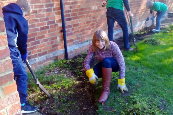 Team Work - GO 4th Members digging up the weeds at Village Hall http://www.go4th.org.uk